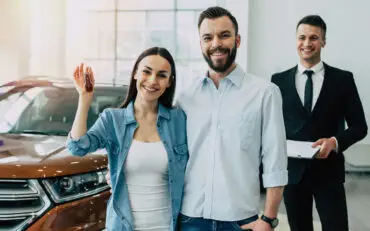 Young couple standing outside their new home in Baldivis after securing a first home buyer mortgage.