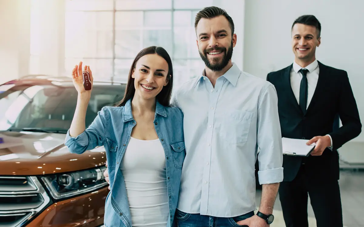 Young couple standing outside their new home in Baldivis after securing a first home buyer mortgage.